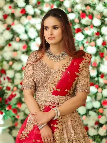 Another shot of this stunning reception look. The makeup is natural and glowing, perfectly complementing the floral backdrop.