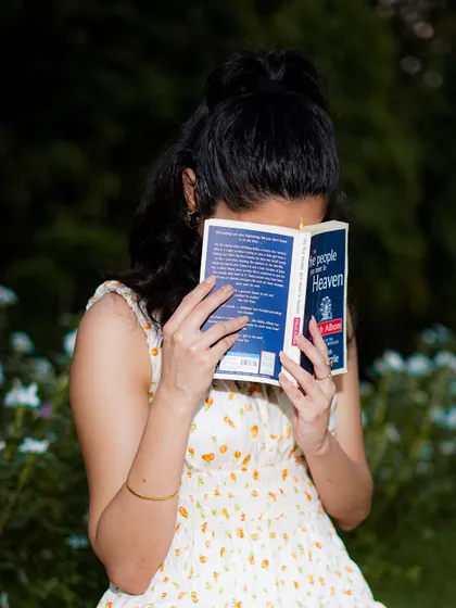 A creative and candid-style portrait. Using a prop like a book can help you relax and allows us to capture a different side of your personality.