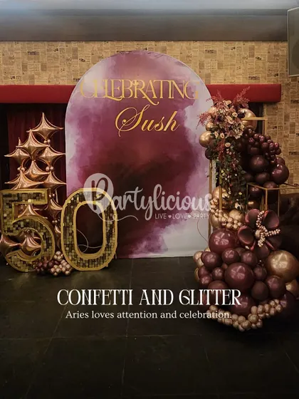 Celebrating a 50th birthday in style. This setup shows our expertise in creating elegant and glamorous decor for adult celebrations. The rich burgundy and gold palette, combined with a custom backdrop and sparkling number display, creates a sophisticated and celebratory atmosphere.