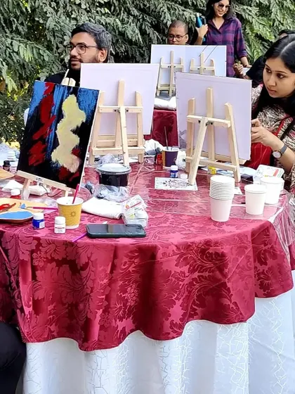 A table of participants deeply engaged in creating their abstract art pieces. The outdoor setting under the winter sun provided a wonderful, relaxed atmosphere for the workshop.
