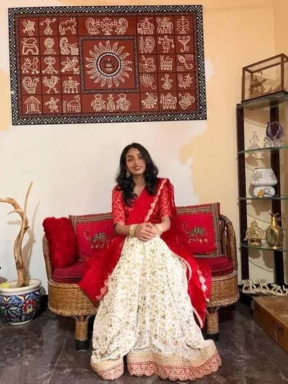 A classic red and white lehenga. The white skirt has a delicate floral print and the red blouse has matching embroidery.