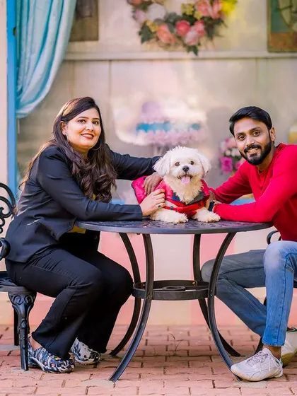 A beautiful family portrait with a couple and their adorable dog. This shot is full of warmth and happiness, perfect for any dog-loving couple.