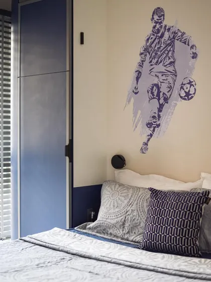 For the football lover, we added a custom wall decal. It's a simple but effective way to personalize the space and reflect the child's interests.