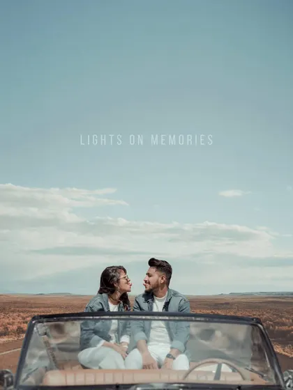 A couple in a convertible car looks at each other against a vast, open landscape. This "road trip" themed pre-wedding photo tells a story of adventure and togetherness.