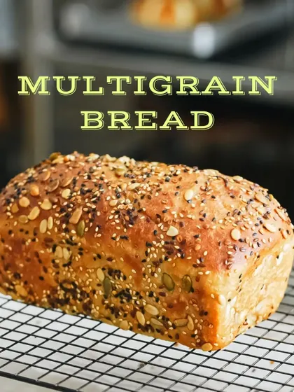 A beautiful loaf of multigrain bread, fresh from the oven. We styled this shot to highlight the texture of the crust and the variety of seeds on top.