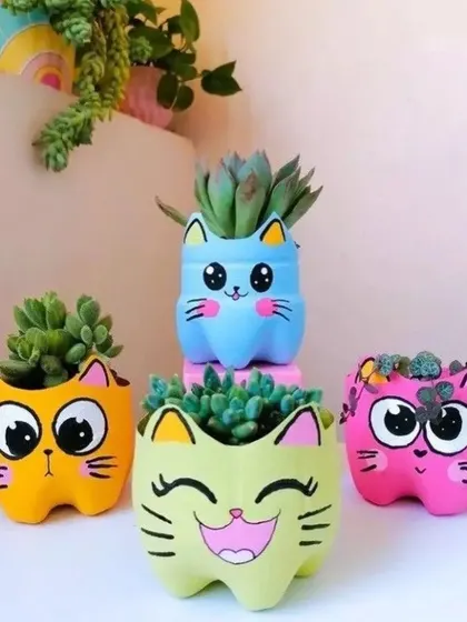 Another look at these colorful cat planters. I can create them in various expressions and colors to match your style, making them a great personalized gift or garden accessory.