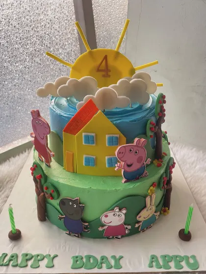 A sunny day with Peppa Pig and her family. This two-tier cake brings the beloved cartoon to life with a bright blue sky, green hills, and all the main characters ready for a party.