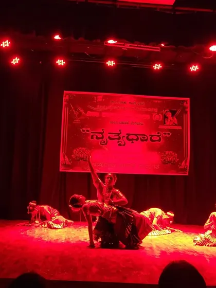 A dramatic, red-lit stage moment from a group performance at a local dance festival. We use stage lighting and production elements to enhance the mood and storytelling of our choreography.