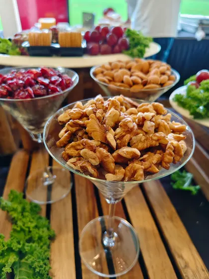 Healthy and elegant snack options like walnuts, almonds, and cranberries, beautifully presented in martini glasses for the Bombay Gymkhana celebration.