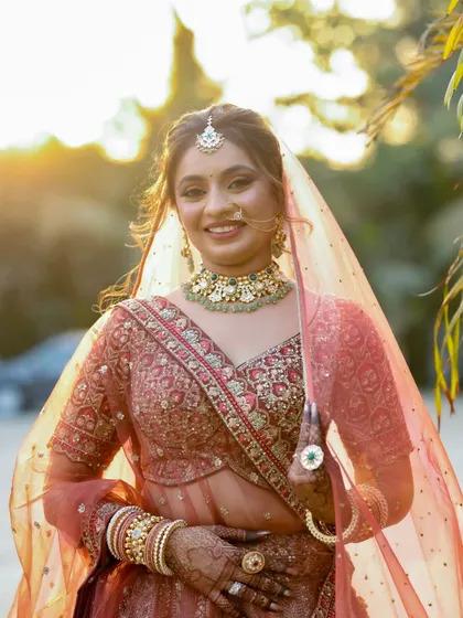 A stunning shot of the bride with her veil, captured in the golden hour light which makes her skin glow beautifully.