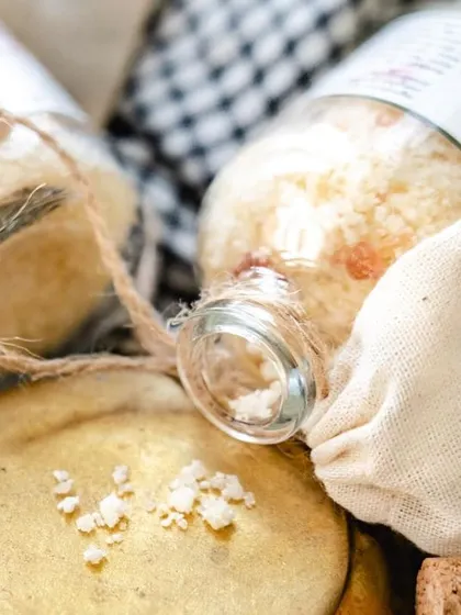 The mouth of the bath salt bottle, showing the cork stopper and the muslin bag tied with twine. Every detail is chosen to be beautiful and eco-friendly.