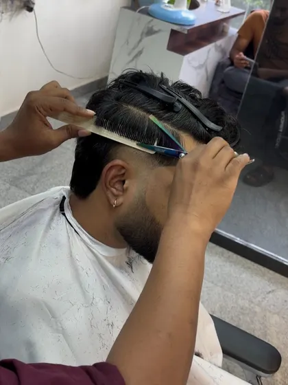 A close-up of the scissor-over-comb technique, which I use to blend and refine haircuts for a seamless finish.
