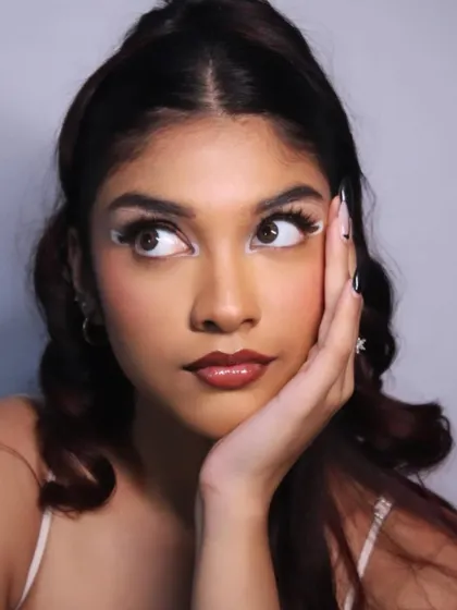 A candid, expressive shot that adds personality to this high-fashion look.