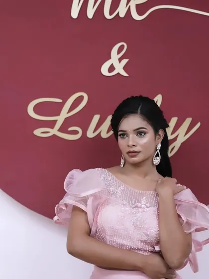 A lovely portrait showcasing the soft makeup and elegant hairstyle.