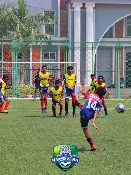 Stay sharp, aim high. A young player practices his shooting technique, aiming for power and precision against a wall of defenders.