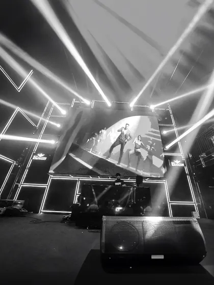 A black and white shot that captures the drama of my AV setup. The powerful stage lights and the visuals on the screen work together to create a stunning, concert-like atmosphere, even at corporate events.