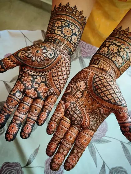This intricate design was created for the Gangaur festival. It blends floral, peacock, and geometric patterns for a full and festive look, perfect for this important celebration.