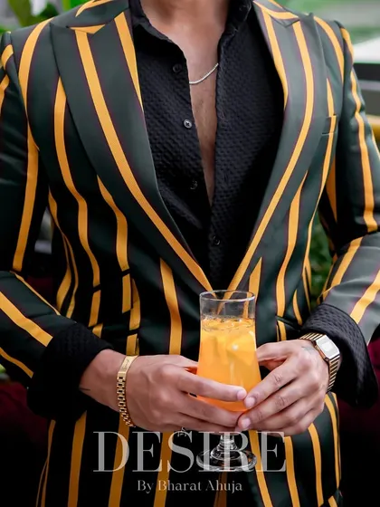 A detail shot of the green and yellow striped blazer. The bold pattern and rich colors are designed for the man who loves to stand out.