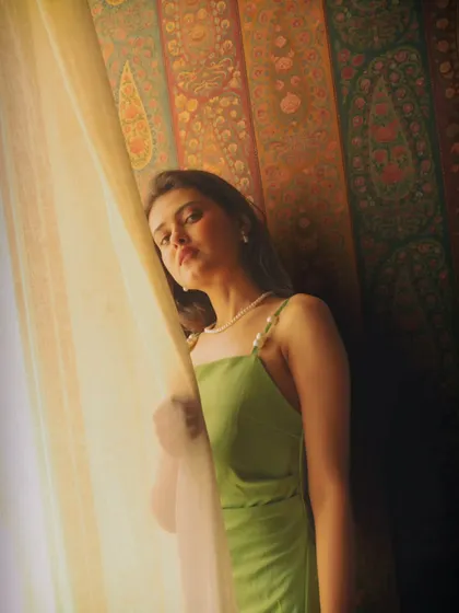 A pensive, thoughtful moment by the window. I love how the light and shadow play across her face, adding depth and mood to the shot.