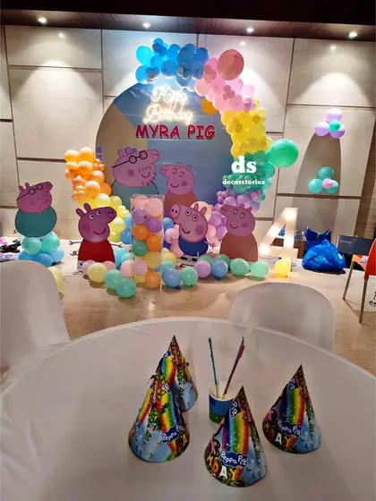 The view from the party table at a Peppa Pig celebration. I ensure every detail, including party hats and table settings, matches the theme to create a cohesive and immersive experience for the kids.