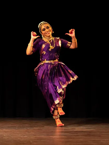 Meera Krishna in a joyful pose, her smile radiating the happiness she finds in dance.