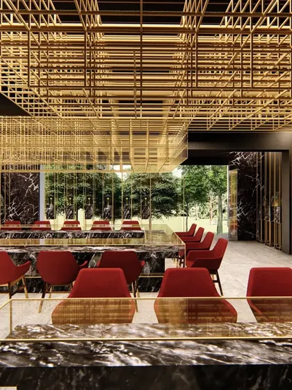 Another perspective of the Lucknow jewelry showroom, revealing how the suspended brass mesh ceiling grid extends through the space. This fixture defines the primary circulation path while filtering light and creating a sense of enclosure.