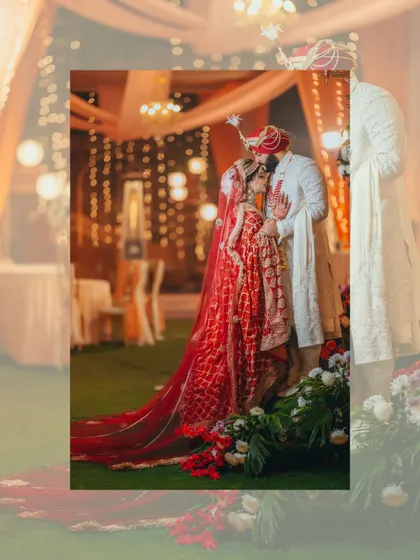 An artistic, softly focused shot of the couple sharing an intimate moment, framed by the warm glow of the wedding decor.
