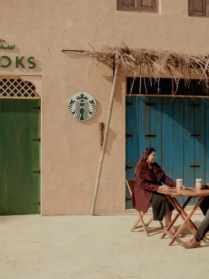 A wide shot showing the full "Starbucks in the desert" setup, a truly unique pre-wedding concept.