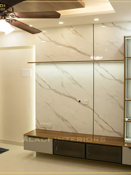 A sleek TV unit with a white marble-finish back panel and a wooden base. The integrated glass shelves provide space for display items, keeping the look clean and modern.