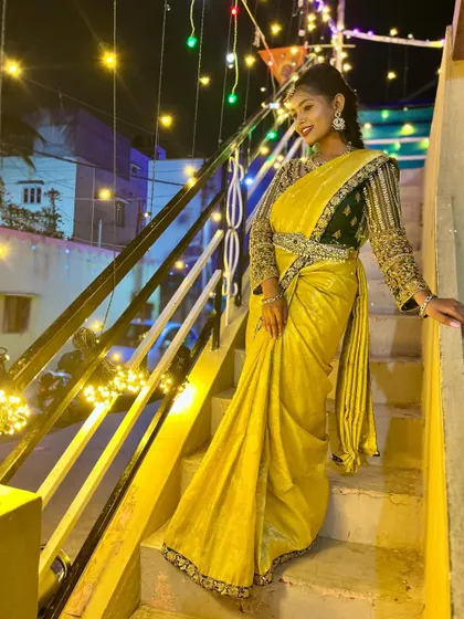 A full-length shot of the model on a staircase, showing the complete look.
