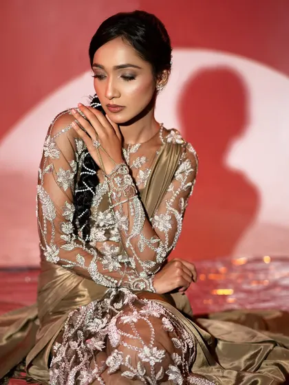 The beauty of this look is in the details. The delicate, shimmering embroidery catches the light perfectly, making it an ideal choice for a photographed event like an awards night.