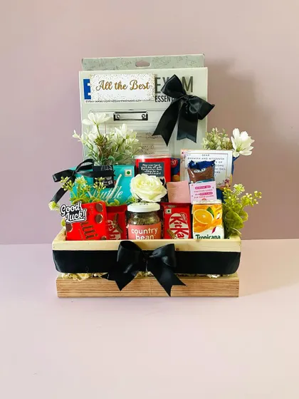 An "All the Best" hamper for a student facing board exams. I filled it with essentials like a clipboard, stationery, and brain-food snacks for good luck.