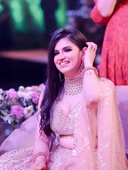 A beautiful candid shot of the bride-to-be enjoying her engagement party. Her radiant smile and the soft lighting create a warm and joyful atmosphere.