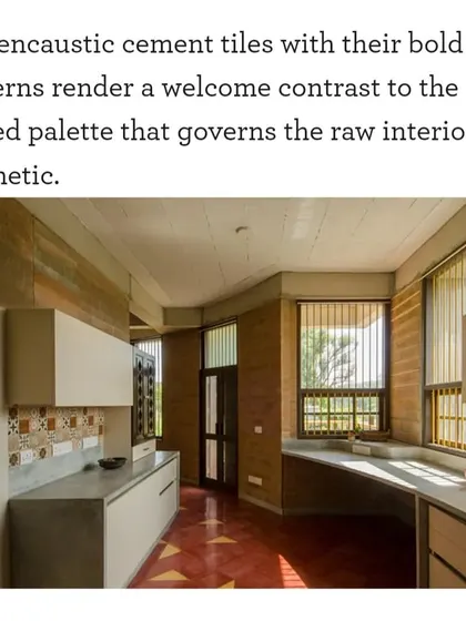 A clipping from Good Homes magazine describing the kitchen in "Breathe." It points out how the bold patterns of the cement tiles provide a welcome contrast to the raw, muted interior aesthetic.