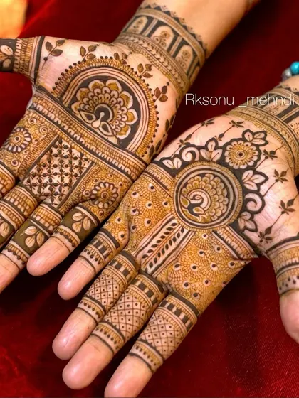 Symmetrical beauty in this bridal design, where both hands feature a central peacock mandala. The surrounding space is filled with a mix of geometric lines and delicate dot work for a balanced look.
