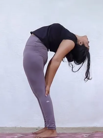 A supported standing backbend (Ardha Chakrasana) is a great way to begin exploring back flexibility safely. We use modifications like this to build confidence and strength.