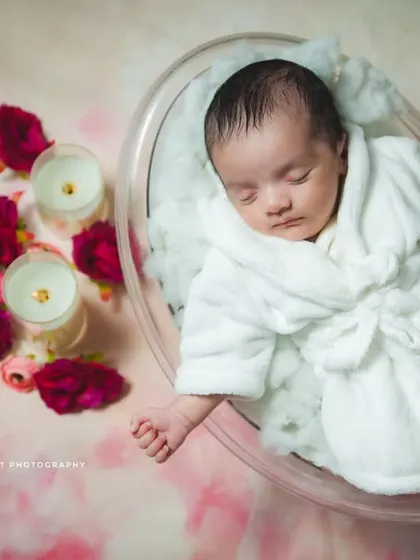 A fun and unique concept for a newborn shoot is this 'Spa Day' theme. Your baby is comfortably posed in a miniature tub with a tiny bathrobe, surrounded by candles and flowers for a truly adorable and memorable portrait.