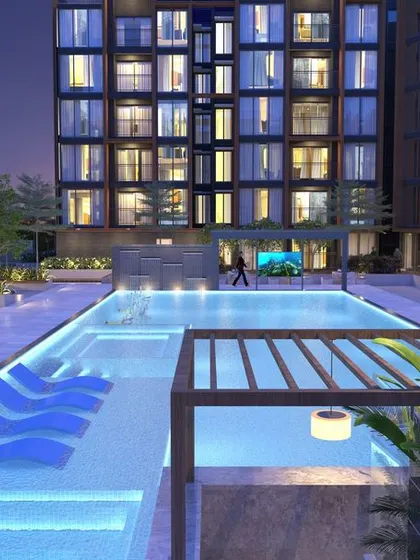 The pool at Casagrand Southbrooke at dusk, where underwater lighting and illuminated loungers create a sophisticated and inviting ambiance for evening relaxation.