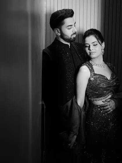 A timeless black and white portrait of the couple. The soft lighting and their close embrace create an image that is both elegant and deeply romantic, perfect for their Sangeet album.