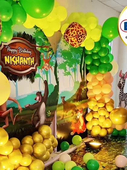 A vibrant Jungle Book theme with a full character backdrop and a lush green and yellow balloon garland.