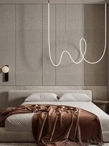 Minimalism is at the heart of this design, which features a unique, free-form LED light fixture as a piece of art. The low-profile bed and simple color palette create a clean and uncluttered environment.