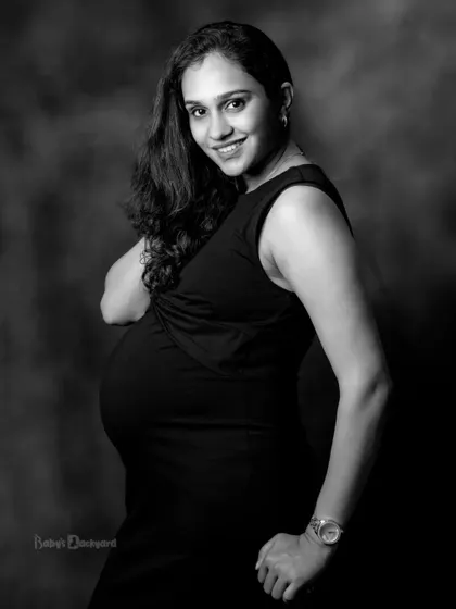 A beautiful, happy smile that says it all. This classic black and white portrait captures the pure joy and glow of pregnancy.