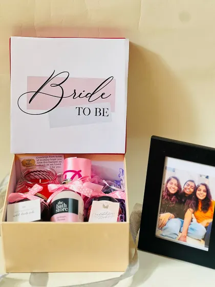 A complete 'Bride to be' gift set, showing the open box of goodies next to the personal photo frame. It's a perfect mix of fun treats and sentimental value.