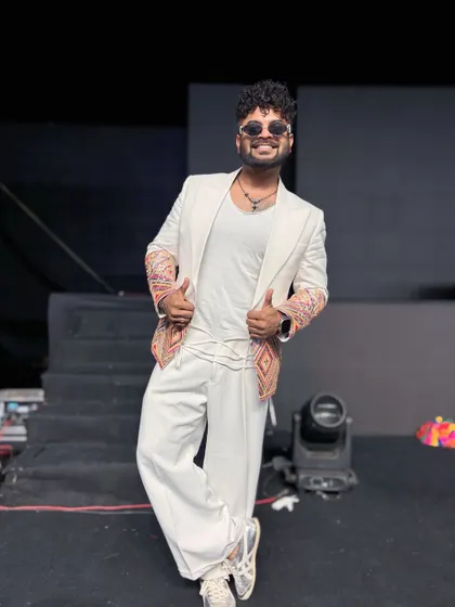 A custom white blazer with embroidered sleeves, perfect for a destination wedding in Goa.