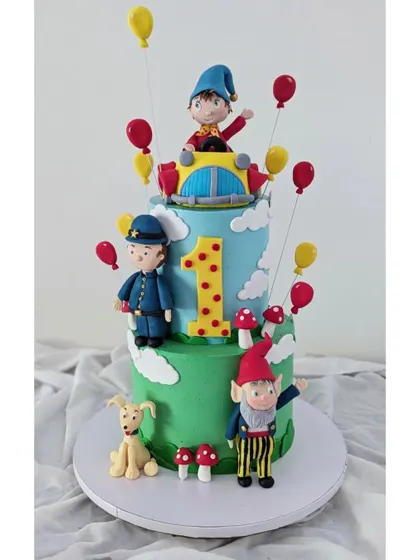 Bringing Enid Blyton's Noddy to life was a dream. This cake features Noddy in his car, Big Ears, and Officer Plod, all crafted from fondant for a nostalgic first birthday.