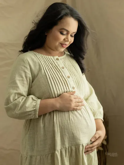 A serene solo portrait of the mother-to-be. The soft lighting and your gentle expression create a peaceful and beautiful image.