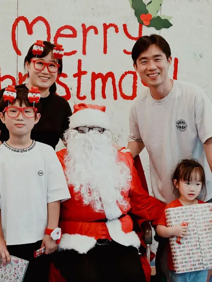 Another happy family captures a memory with Santa.