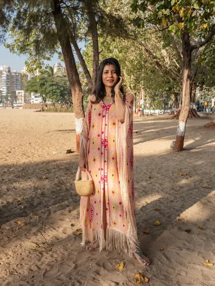 Looking for Rakhi outfit inspiration? This beautiful pink bandhani print kaftan with fringe details is a perfect choice for a relaxed yet festive celebration. It's comfortable, chic, and effortlessly stylish.