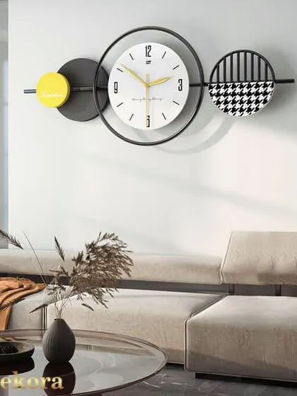 This modern wall clock uses geometric shapes and a bold color palette of yellow, black, and white to create a piece of pop art for your wall.
