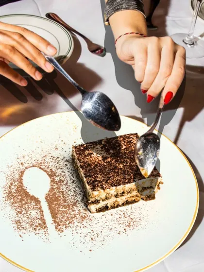 Sometimes, indulgence is the only answer. Here, two spoons dive into our rich and creamy Tiramisu, a classic Italian dessert that's the perfect end to any meal.